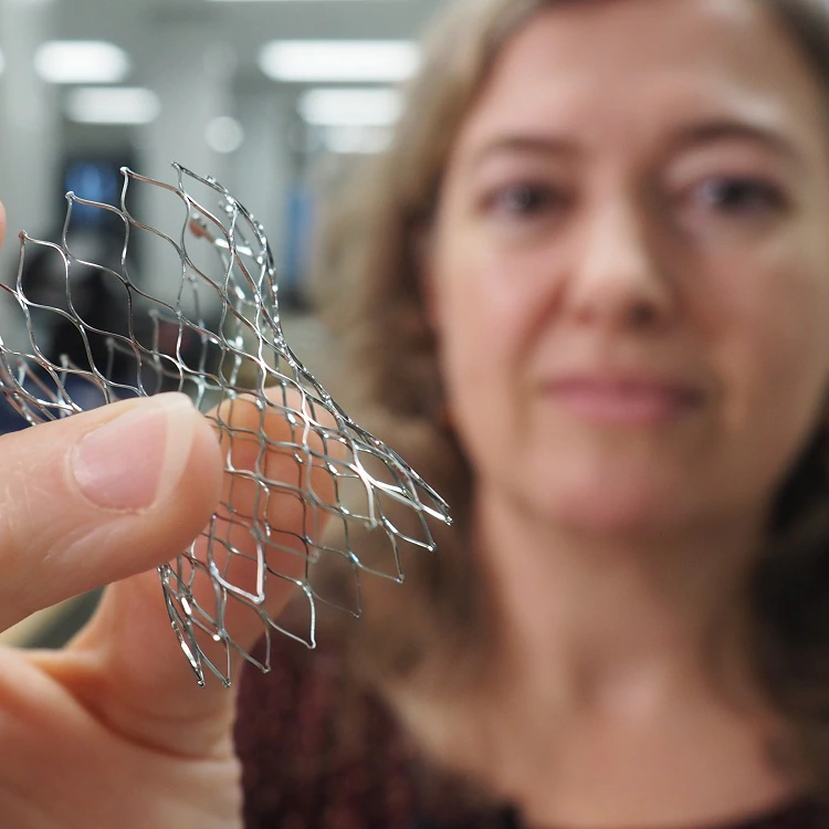   Cynthia Clague holds part of a heart valve made from nitinol