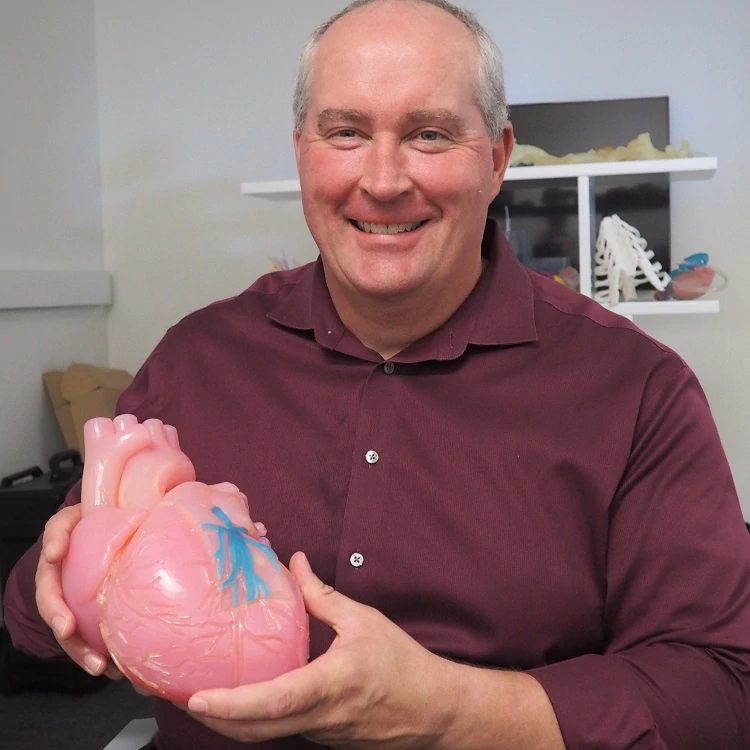   Mark Bucheger holds a 3D printed model
