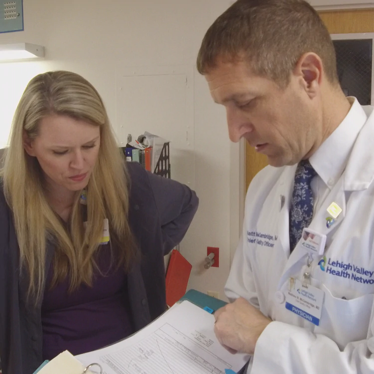   Dr. Matt McCambridge talks with Michelle Crochunis, LPN, at Lehigh Valley Hospital - Schuylkill in Pottsville, Pa.