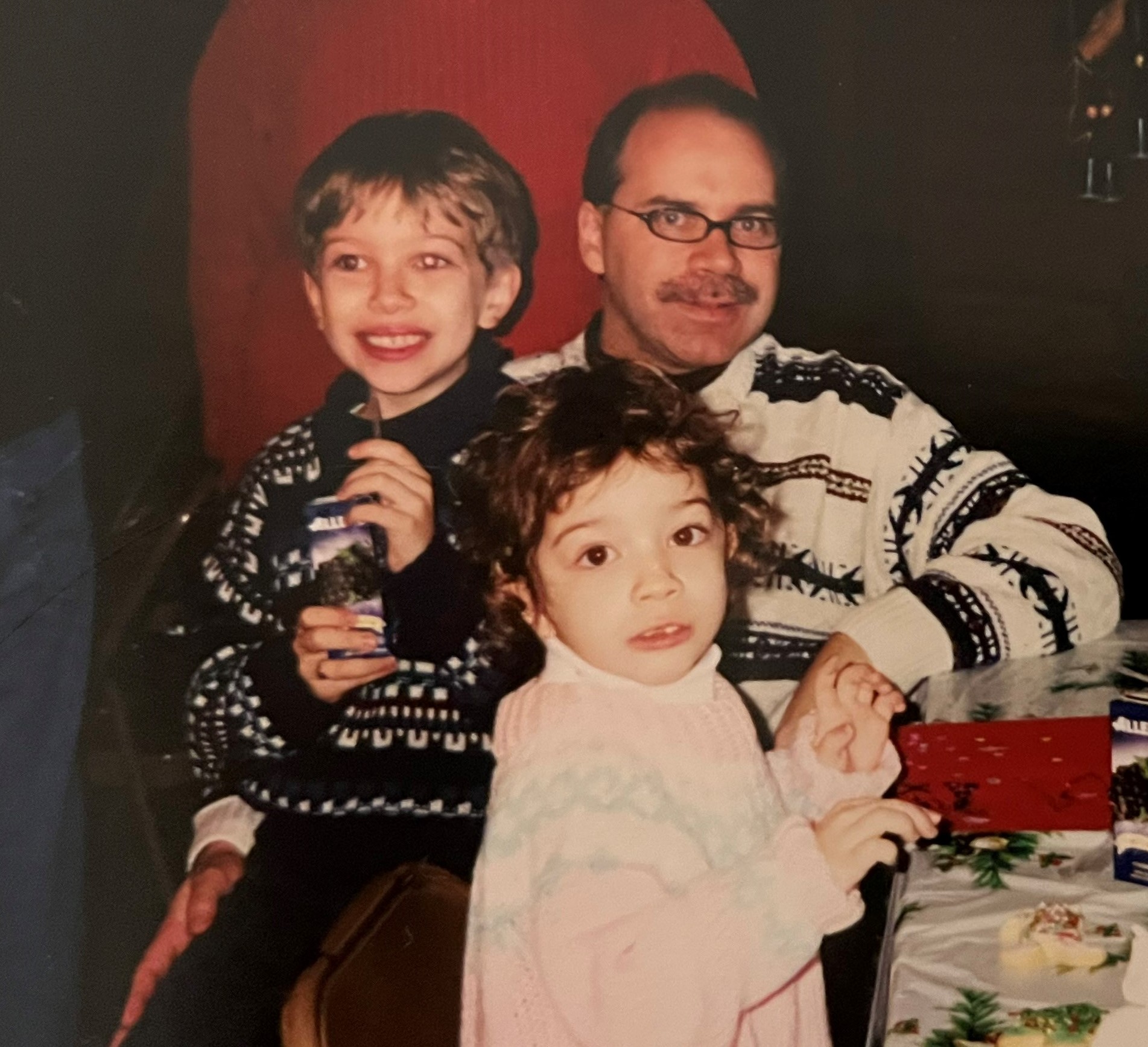 Robbins with her dad and brother, decorating cookies at a Medtronic Canada Christmas party