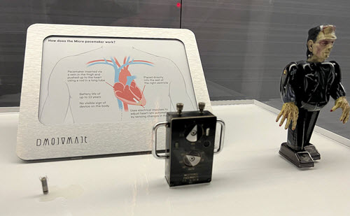 An early Medtronic pacemaker prototype (center) paired with a Micra™ (left)