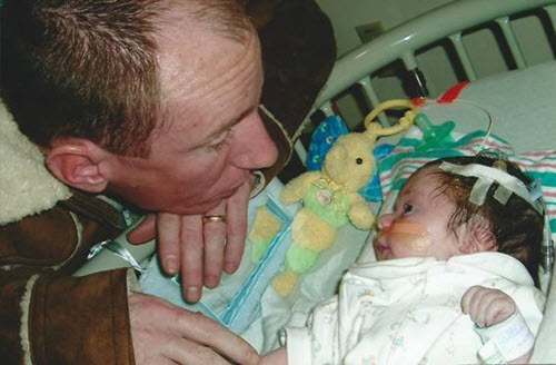 Brian Martinage checks on his infant son hours after his first brain surgery.